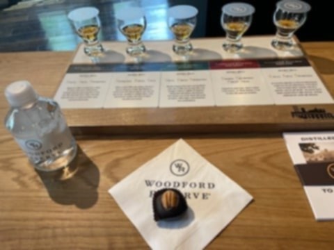 Woodford Reserve whiskey tasting flight with chocolate and water bottle