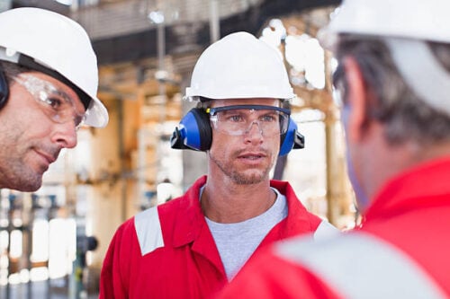 Engineers on a shop floor talking