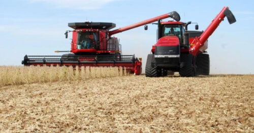 Red combine harvesting in an Iowa field